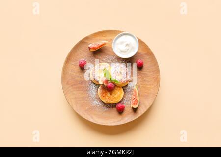 Teller mit Quark-Pfannkuchen und Himbeeren und Obst auf farbigem Hintergrund Stockfoto