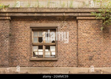 Kaputte Fenster in einer alten, ruinierten Fabrik Stockfoto