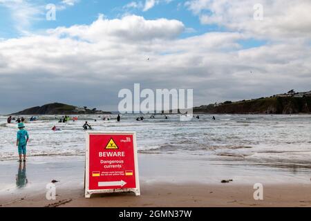 Am Bantham Beach in Devon warnt ein RNLI-Schild Schwimmer vor gefährlichen Strömungen. Es wird von vielen Menschen ignoriert. Stockfoto