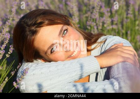 Porträt einer glücklichen schönen Frau lächelnd Blick auf Sie in Lavendel Feld Stockfoto