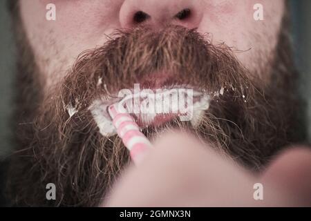 Ein Mann mit einem Bart, der seine Zähne putzt Stockfoto