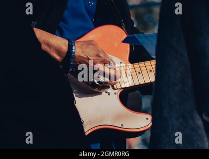 Nahaufnahme einer Hand von einer farbigen Person, die eine E-Gitarre spielt Stockfoto