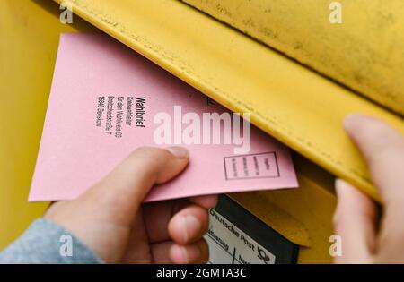 Sieversdorf, Deutschland. September 2021. Eine Person legt ihre postalischen Stimmdokumente in eine Mailbox der Deutschen Post. Der Umschlag enthält den aktuellen Stimmzettel und die Stimmdokumente als Briefwahl für die Bundestagswahl am Sonntag, 26. September 2021. Quelle: Patrick Pleul/dpa-Zentralbild/ZB/dpa/Alamy Live News Stockfoto