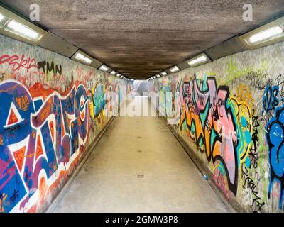 U-Bahnen in vielen Städten sind Orte, die dunkel und gefährlich sind. Aber hier sehen wir eines in Belfast, das durch lebendige, bunte Graffiti i verwandelt wurde Stockfoto