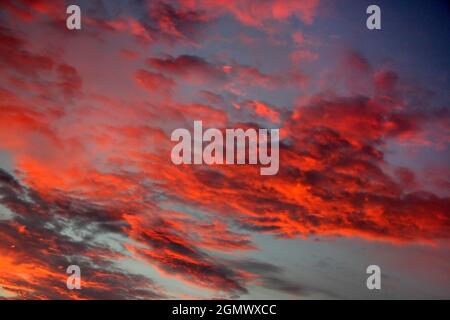 Oxfordshire, England - 25. August 2017 Tiefe rote Wolken bei Sonnenuntergang über meinem Haus in Radley Village, Oxfordshire England. Stockfoto