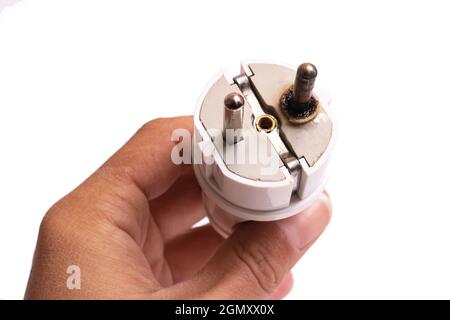 Verbrannter elektrischer Stecker in der Hand isoliert auf weißem Hintergrund Nahaufnahme Stockfoto