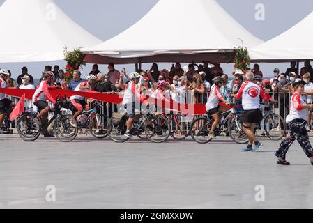 Izmir, Türkei - 9. September 2021: Fahrradfahrer-Gruppe, die eine riesige türkische Flagge von Afyon nach Izmir trägt, um dem Bürgermeister von Izmir Tunc als Geschenk zu geben Stockfoto