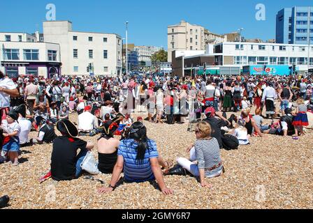 Als Piraten gekleidete Menschen nehmen am 22. Juli 2012 am Strand von Hastings in East Sussex, England, am Piratentag Teil. Das 2009 begonnene Spiel war ein Versuch, den Guinness-Weltrekord für die größte Anzahl von Piraten zu gewinnen, die sich am Strand versammelten. Stockfoto