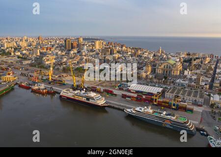 Luftaufnahme der Expeditionskreuzschiffe Midnatsol (Hurtigruten Cruises) und World Explorer (Nicko Cruises) mit der Skyline der Stadt bei Sonnenaufgang, Punta d Stockfoto