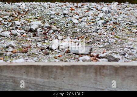 Unschärfe viele zerkleinerte Steine in Hügel oder Denkmal. Kies der juden Menschen. Weißes Gestein, Mineralien, Archäologie, Ausgrabungen. Draußen, draußen. Nicht fokussiert Stockfoto