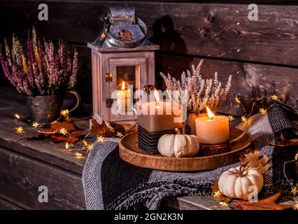 Schöne Herbstterrasse Dekoration mit Kürbissen, Laterne, Pflanzen und Blumen Stockfoto