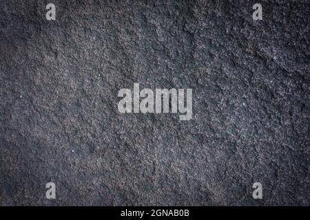 Steinhintergrund. Natürliche Struktur aus Granit. Leichte Vititation an den Rändern. Stockfoto