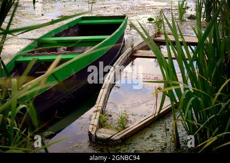 Ein altes Boot auf dem See an einem bewölkten Tag Stockfoto