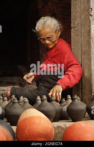 Eine ältere Frau, die in Bhaktapur, einer alten Stadt, die für Kunsthandwerk und traditionelles Leben berühmt ist, Keramik herstellte. 10. August 2007. Bhakatapur, Nepal. Stockfoto