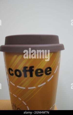 Vor der Arbeit oder während Sie die Morgenzeitung mit dem Klang der Musik lesen und in der Natur Sitzen, Jeden Morgen Eine Tasse Kaffee von Starbucks Stockfoto