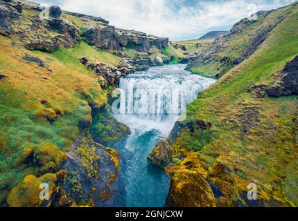 Atemberaubende Morgenlandschaft mit Wasserfall auf dem Skoga Fluss. Luftaufnahme im Sommer von der Touristenwanderung vom berühmten Skogafoss Wasserfall bis zum Gipfel des riv Stockfoto