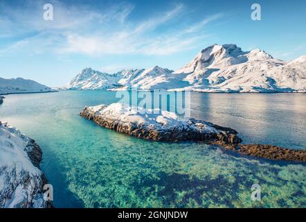 Blick von der fliegenden Drohne auf den Andopen-Fjord mit der Kakernbrua-Brücke im Hintergrund. Unglaubliche Winterlandschaft des norwegischen Meeres. Wunderbare Morgenszene von Stockfoto