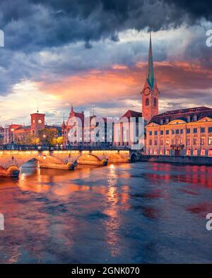 Сharm der alten Städte Europas. Dramatische Abendansicht der Fraumünster Kirche. Traumhaftes Sommer-Stadtbild von Zürich, Schweiz. Sonnenuntergang auf Limmat Stockfoto