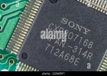 Flügelbeine oder Pinouts eines integrierten Halbleiters von Sony auf einer grünen leiterplatte. Für die Elektronik-Technologie, weltweite Chipknappheit Stockfoto