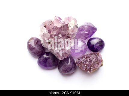 Wunderschöne Edelsteine und Druse aus natürlichem purpurfarbenem Amethyst auf weißem Grund. Große Kristalle aus Halbedelsteinen. Stockfoto