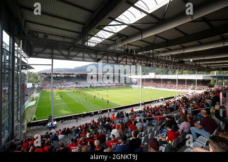 Freiburg Im Breisgau, Deutschland. September 2021. Fußball: Bundesliga, SC Freiburg - FC Augsburg, Matchday 6, Dreisamstadion: Zuschauer sitzen vor dem Start des letzten Heimspieles des SC Freiburg im Dreisamstadion auf der Tribüne. Der Verein zieht dann in ein neues Stadion. Quelle: Philipp von Ditfurth/dpa - WICHTIGER HINWEIS: Gemäß den Bestimmungen der DFL Deutsche Fußball Liga und/oder des DFB Deutscher Fußball-Bund ist es untersagt, im Stadion und/oder vom Spiel aufgenommene Fotos in Form von Sequenzbildern und/oder videoähnlichen Fotoserien zu verwenden oder zu verwenden./dpa/Alamy Live News Stockfoto