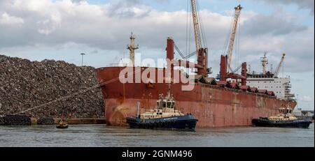 Southampton, England, Großbritannien. 2021. Schlepper manövriert ein Bulk-Carrier-Schiff zu ihrem Liegeplatz im Hafen von Southampton, einem britischen Hafen.Southampton. Stockfoto