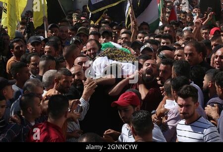 Jenin. September 2021. Trauernde und Verwandte tragen am 26. September 2021 den Leichnam des Palästinensers Osama Soboh während seiner Beerdigung im Dorf Burqin westlich der Stadt Jenin im Westjordanland. Palästina verurteilte am Sonntag israelische Soldaten für die Tötung von fünf Palästinensern bei zwei verschiedenen Zwischenfällen im nördlichen Westjordanland und nordwestlich von Jerusalem. Quelle: Nidal Eshtayeh/Xinhua/Alamy Live News Stockfoto
