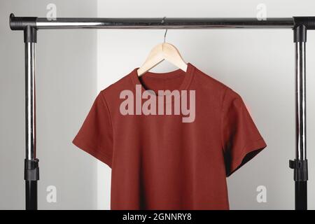 Leeres rotes burgunderfarbenes T-Shirt-Modell auf Kleiderbügeln. Bella Leinwand Modell. Stockfoto