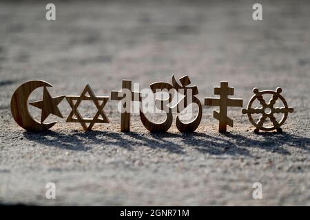 Religiöse Symbole auf Sand. Christentum, Islam, Judentum, Orthodoxie-Buddhismus und Hinduismus. Interreligiöses oder interreligiöses Konzept. Stockfoto