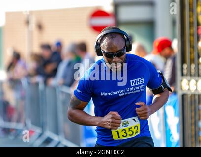 Warrington Running Festival 2021 - Mann mit Kopfhörern überquert die Grenze Stockfoto