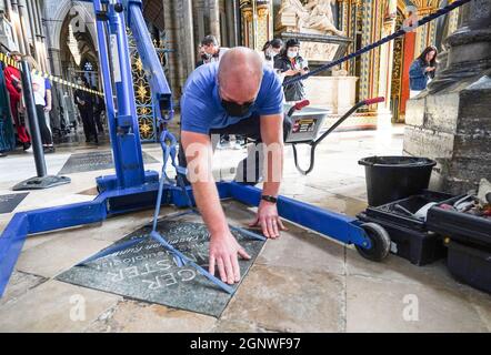 Der Steinmetz Mark Croll installiert in der Westminster Abbey, London, einen Gedenkstein zu Ehren von Sir Roger Banister, neben den Gräbern von Sir Isaac Newton, Charles Darwin und Professor Stephen Hawking. Sir Roger, der im März 2018 im Alter von 88 Jahren starb, war der erste Mann, der in weniger als vier Minuten eine Meile gelaufen war und allgemein angenommen wurde, dass er über die menschlichen Fähigkeiten hinausging, bis er die Leistung an der Universität Oxford am 6 1954. Mai erreichte. Er wurde ein angesehener Neurologe und fühlte sich immer als Wissenschaftler besser als seine Leistungen in der Leichtathletik. Bilddatum: Freitag, 24. September 2021. Stockfoto