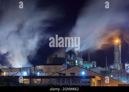 Eine Zellstoff- und Papierfabrik in der Nacht, mit Dampf aus den Schornsteinen Stockfoto