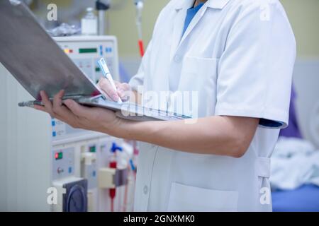 Der Spezialist führt kontinuierliche Nierenersatztherapiegeräte und Injektionspumpen durch. Stockfoto