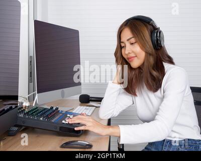 Der Toningenieur überprüft vor Beginn der Arbeiten die Richtigkeit des Audiorecorders. Atmosphäre produziert Musik in einem professionellen Aufnahmestudio. Stockfoto