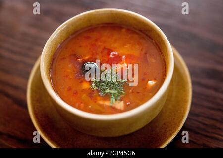 Heiße Suppe mit Fleisch und Gemüse. Traditionelle russische Fleischsuppe - Soljanka. Konzept: Speisekarte für ein Restaurant. Stockfoto