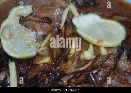 Nahaufnahme des traditionellen pakistanischen Haleem-Gerichts mit Salat und Zitronensaft. Stockfoto