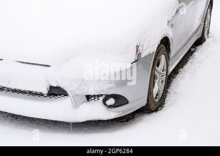 Fallen schlafend nassem Schnee Auto. Schneefall von nassem Schnee. Schnee liegt auf dem Auto. Stockfoto