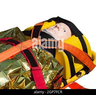 Dummy immobilisiert auf einer Bahre für Transport oder Air Rescue isoliert auf weißem Hintergrund. Stockfoto