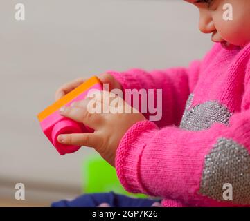 Kleinkind baby girl spielt mit weichem Gummi Bausteine Stockfoto