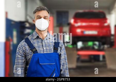 Kfz-Mechaniker Technician Tun Auto Reparatur Diagnose In Gesichtsmaske Stockfoto