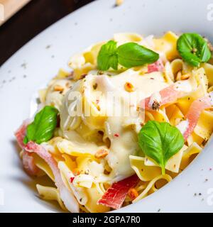 Tagliatelle mit Gorgonzola-Masarpone-Sauce und Schinken. Stockfoto