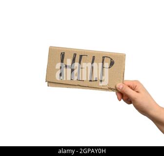Hand hält ein Stück Pappe mit der Aufschrift Help, Mutual Assistance Concept, Homeless, Financial Crisis Stockfoto