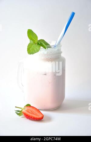 Erdbeer-Milchshake im Glas, gesund proteinreich, lecker Geschmack. Trinken Episode Morgen auf weißem Hintergrund Stockfoto