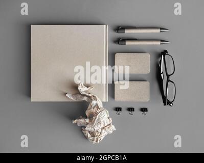 Foto von leerem Kraftpapier Briefpapier auf grauem Papierhintergrund. Draufsicht. Flach liegend. Stockfoto