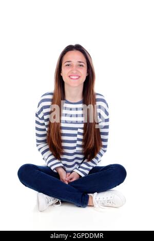 Glücklich Teenager Mädchen sitzen auf dem Boden isoliert auf weißem Hintergrund Stockfoto