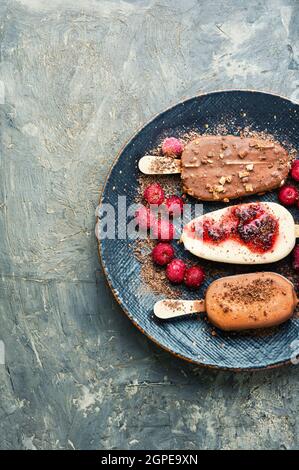 Eis auf Stöcken mit Schokolade.Schokoladenüberzogene Eis mit Kirschmarmelade Stockfoto