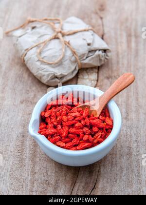 Alternative health care und orientalischen Zutaten getrocknete Tibetischen Goji Beeren auf alten Holz- Hintergrund. Stockfoto