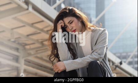 Legen Sie los. Entlassen. Entließ Geschäftsfrau, die draußen auf einer Treppe des Bürogebäudes saß. Depressive junge Geschäftsfrau Arbeitslosigkeit aufgrund von Coronavirus cri Stockfoto