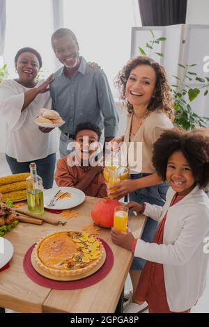 Positive afroamerikanische Familie feiert Danksaggabe mit Großeltern zu Hause Stockfoto