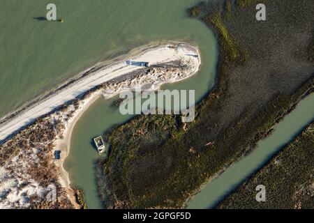 Muster verursacht durch den Sandstrand, der auf den salzmars am östlichen Ende von Folly Beach, South Carolina, trifft, der lokal als The Edge of America bekannt ist. Stockfoto